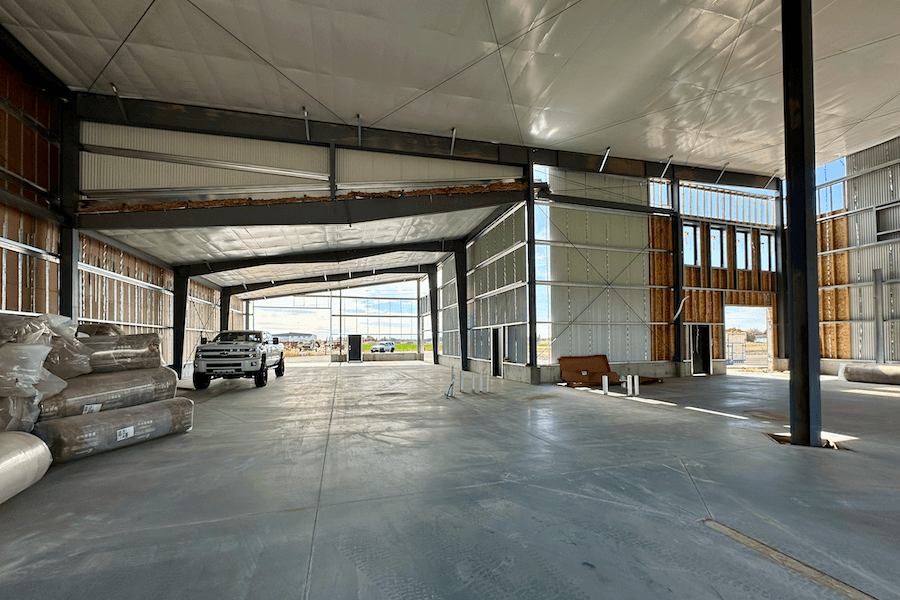 interior large building retail space, poured concrete floors, wood and steel roof interior beams