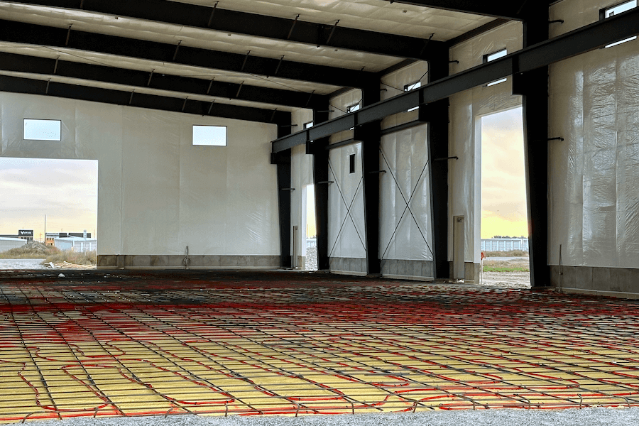 interior large building retail space, poured concrete floors, wood and steel roof interior beams