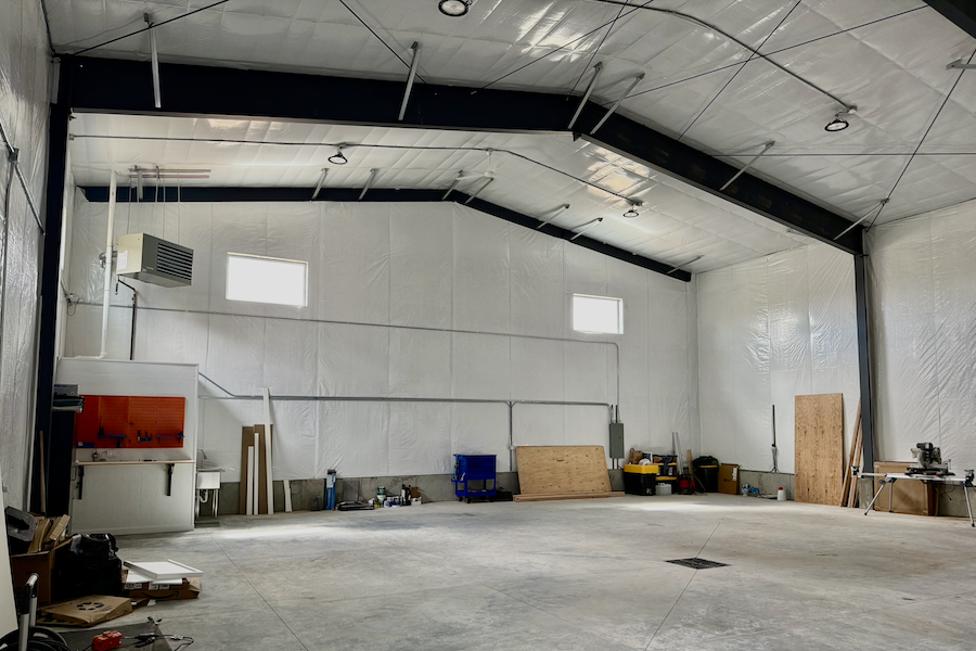interior large building retail space, poured concrete floors, wood and steel roof interior beams