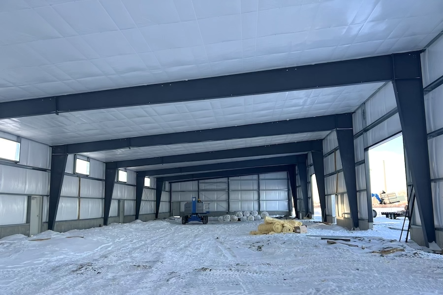 interior large building retail space, poured concrete floors, wood and steel roof interior beams
