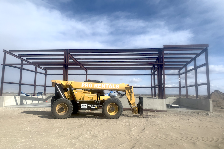 interior large building retail space, poured concrete floors, wood and steel roof interior beams
